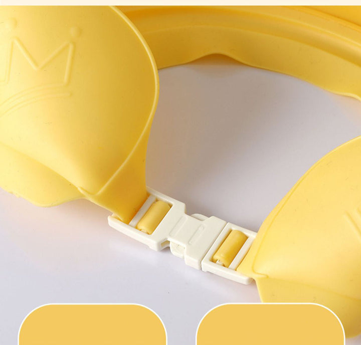 Close-up of the white rear buckle and adjustable band on a yellow bath cap