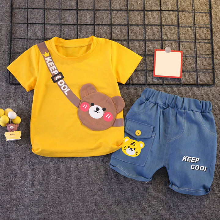 Yellow bear T-shirt and blue elastic-waist shorts laid flat