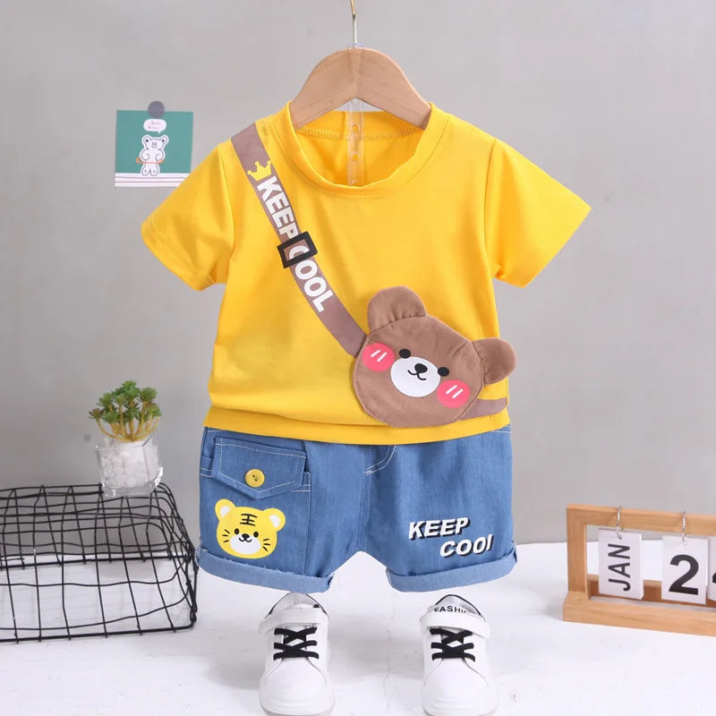 Yellow bear-graphic T-shirt with blue shorts and a small tiger detail