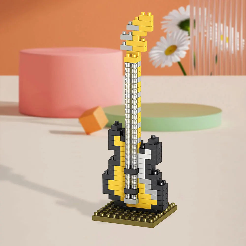 Yellow and black bass guitar building-block model on a display base