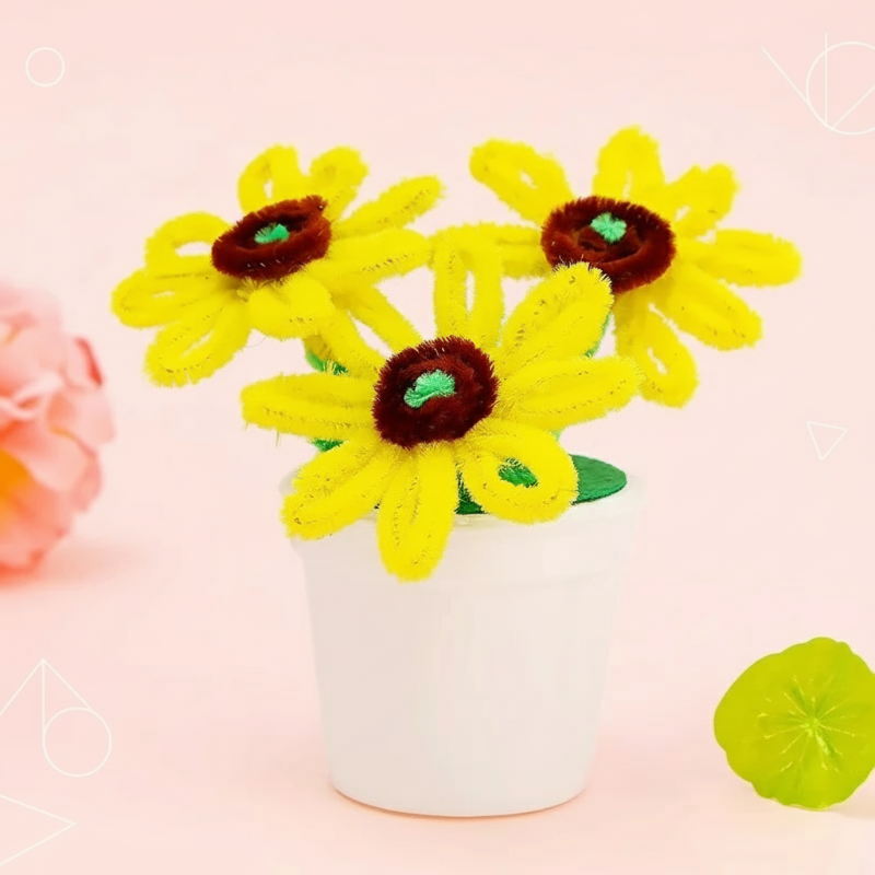 Yellow fuzzy-wire sunflowers with brown centers and green stems in a white pot
