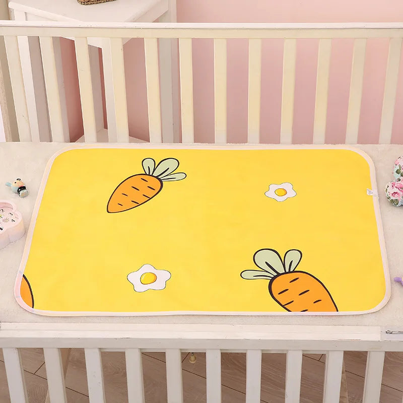 Yellow changing mat with carrots and flowers laid inside a white crib.