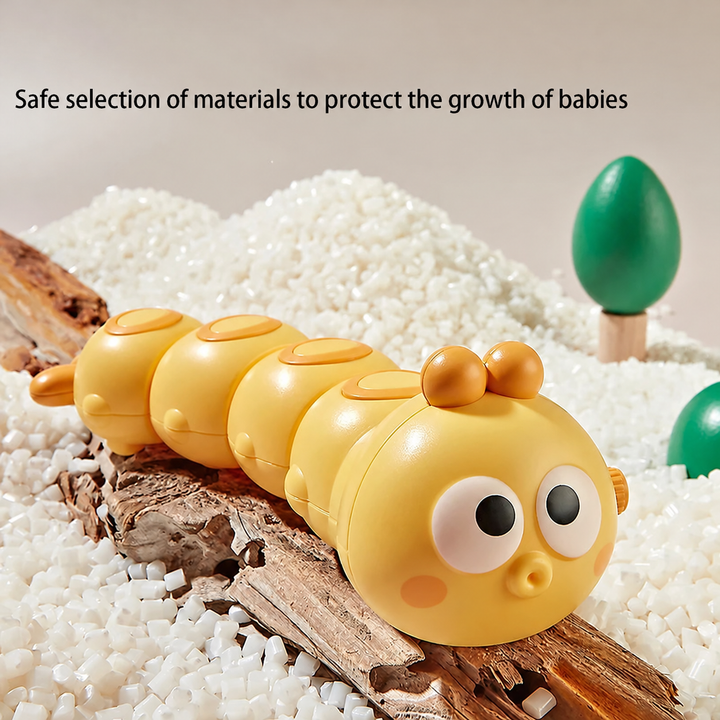 Yellow caterpillar toy with a rounded segmented body on bark