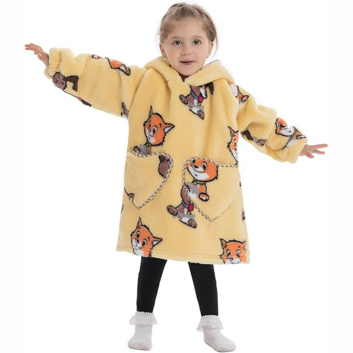 Child wearing a yellow cats-and-dogs-print hooded blanket with arms outstretched