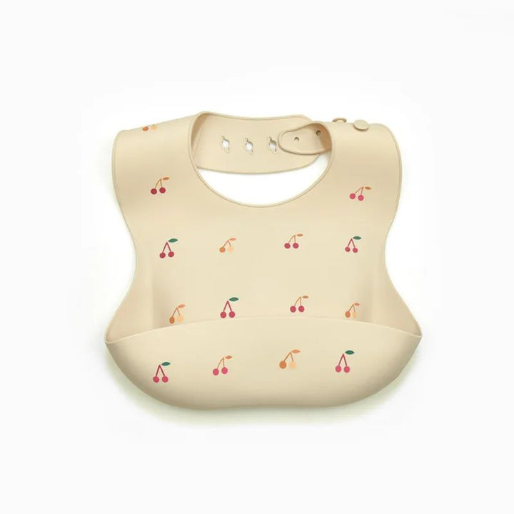 Pale yellow cherry-print silicone bib with a button-style neck closure