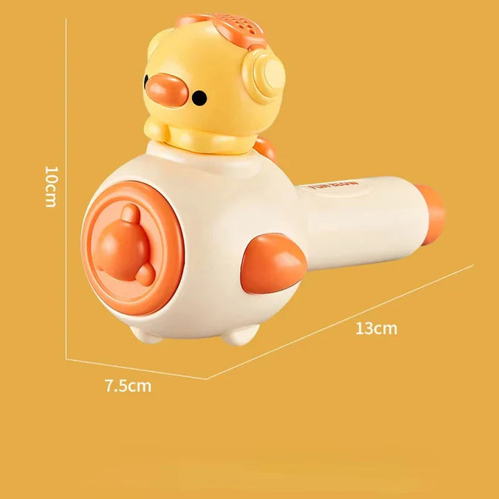 Yellow blowing toy with a chick-shaped head and measurements of 13 x 10 x 7.5 cm.