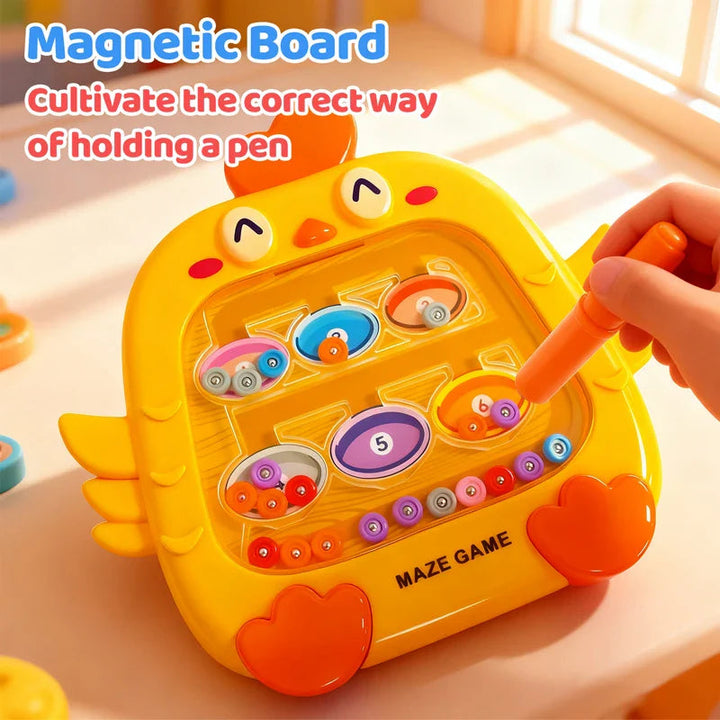 A hand holding an orange magnetic pen against a yellow chick-shaped bead maze.