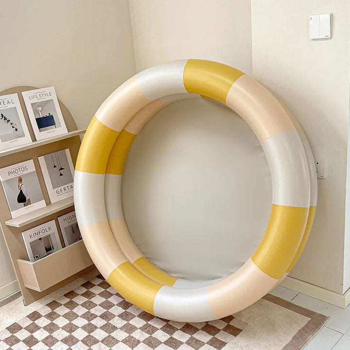 Yellow, cream, and white color-block inflatable pool displayed upright.