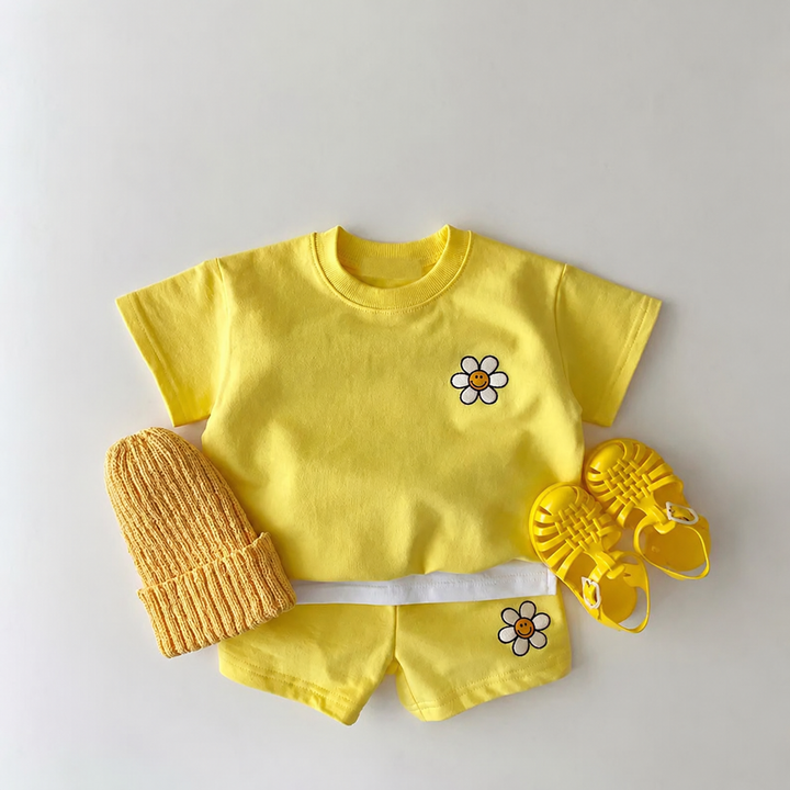 Yellow daisy T-shirt and shorts styled with a matching knit hat and yellow sandals