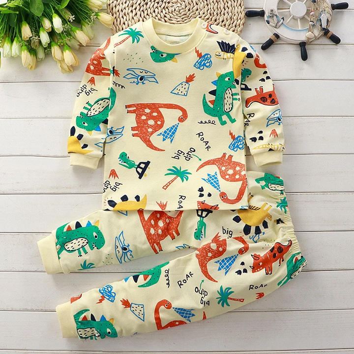 Pale yellow dinosaur-print pajama set with long sleeves and matching pants