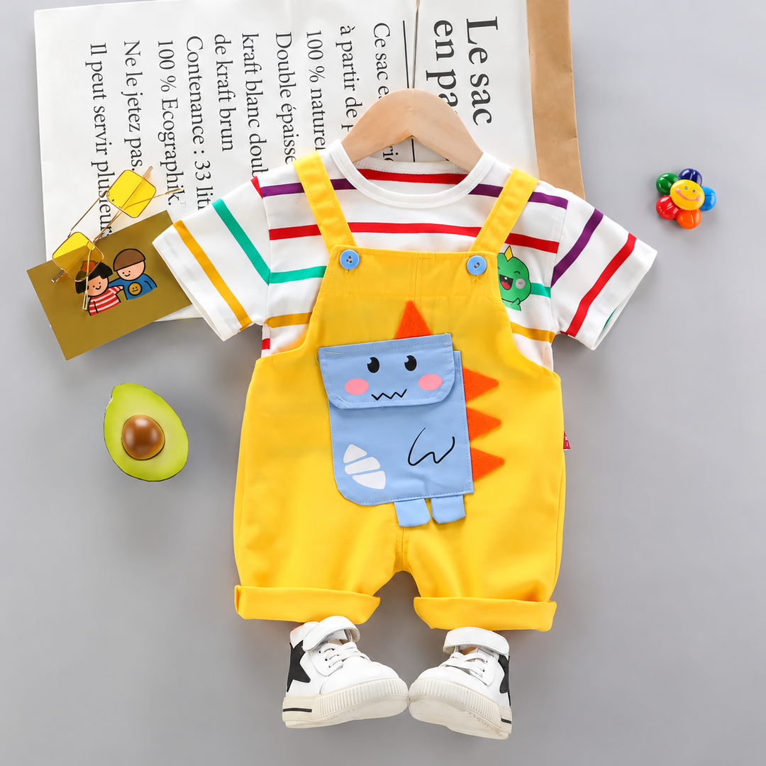 Yellow short overalls with a blue dinosaur detail layered over a multicolor striped short-sleeve shirt