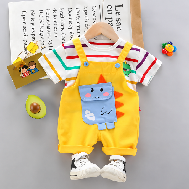 Yellow short overalls with a blue dinosaur detail layered over a multicolor striped short-sleeve shirt