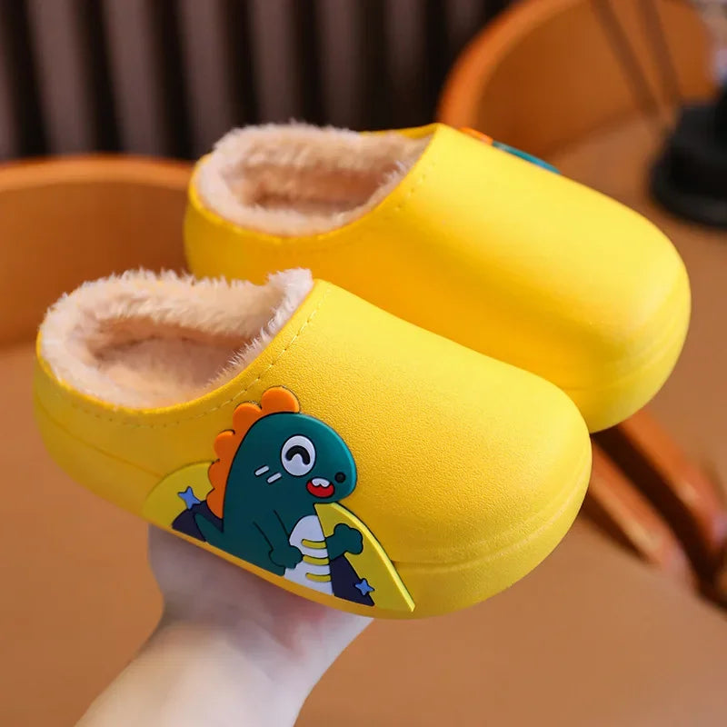 Pair of yellow dinosaur slippers showing the side design and fluffy lining