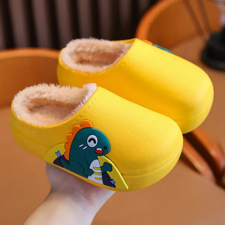 Pair of yellow dinosaur slippers showing the side design and fluffy lining