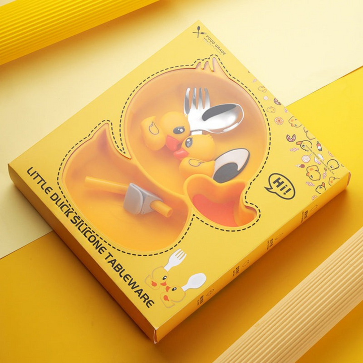 Yellow duck-themed plate with duck-handled cutlery in yellow packaging