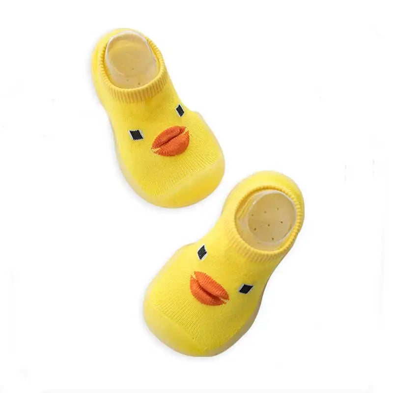 Yellow duck-face sock shoes viewed from above, showing orange beaks and elastic openings