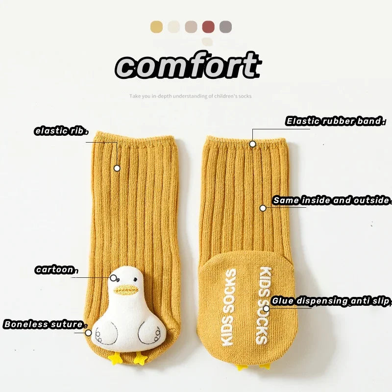 Yellow duck baby socks with annotated details showing ribbed cuffs, raised characters, and non-slip soles
