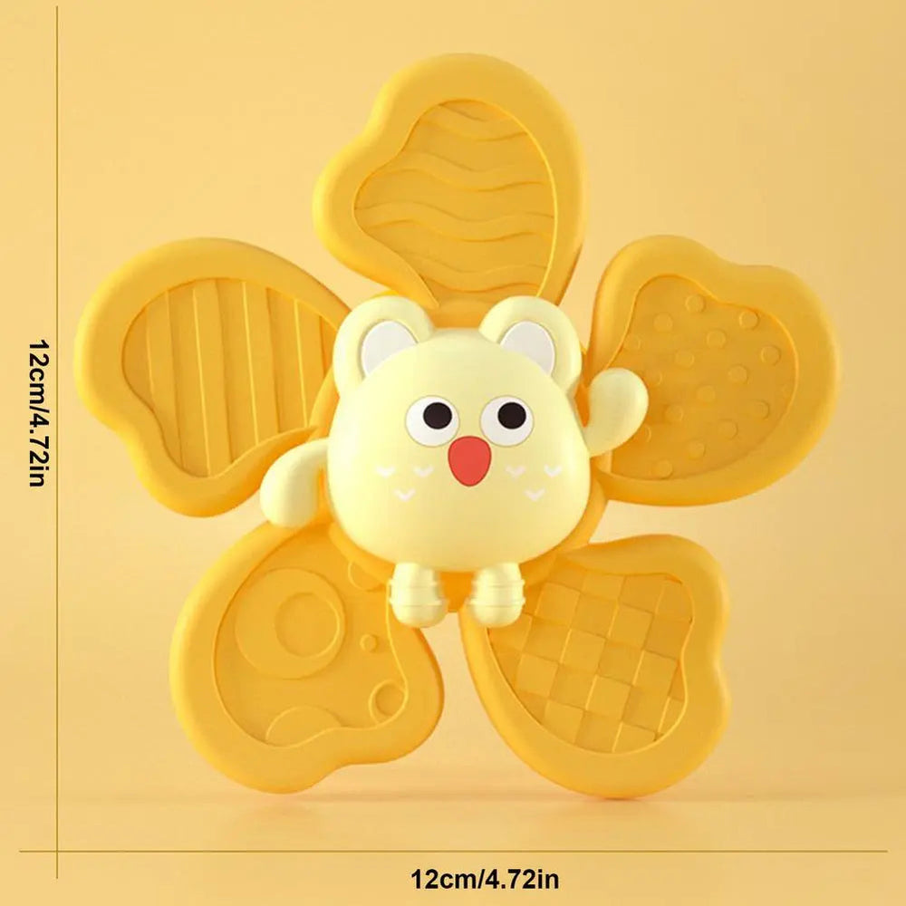 Yellow animal bath spinner with five textured paddles, shown with 12 x 12 cm measurements.