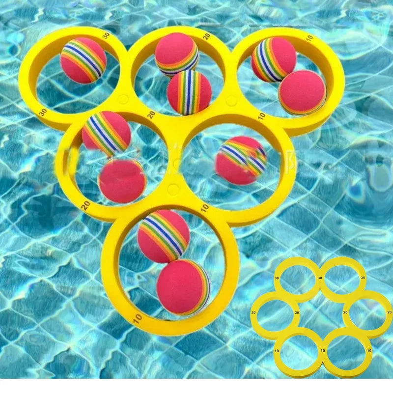 Yellow floating ring target and multicolored balls in a swimming pool
