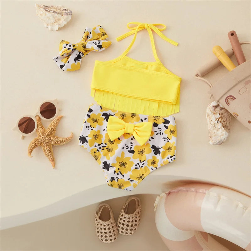 Back view of a yellow bikini with halter ties and a bow on the floral-print bottoms