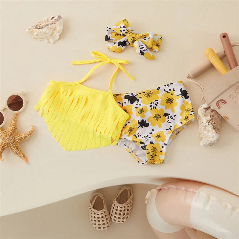 Yellow halter bikini with a fringed top, floral-print bottoms and a matching bow hairband