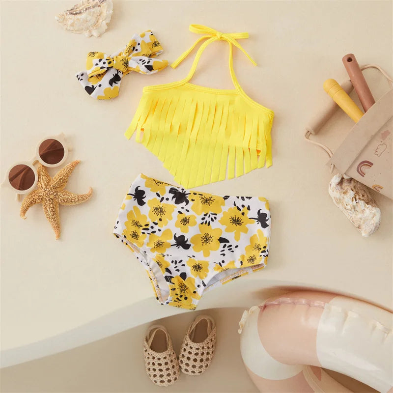 Front view of a yellow fringed bikini top, floral-print bottoms and matching bow hairband