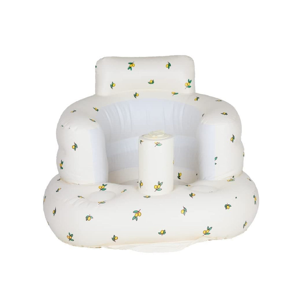 White inflatable baby seat with small yellow and green prints, a raised backrest, and rounded armrests.