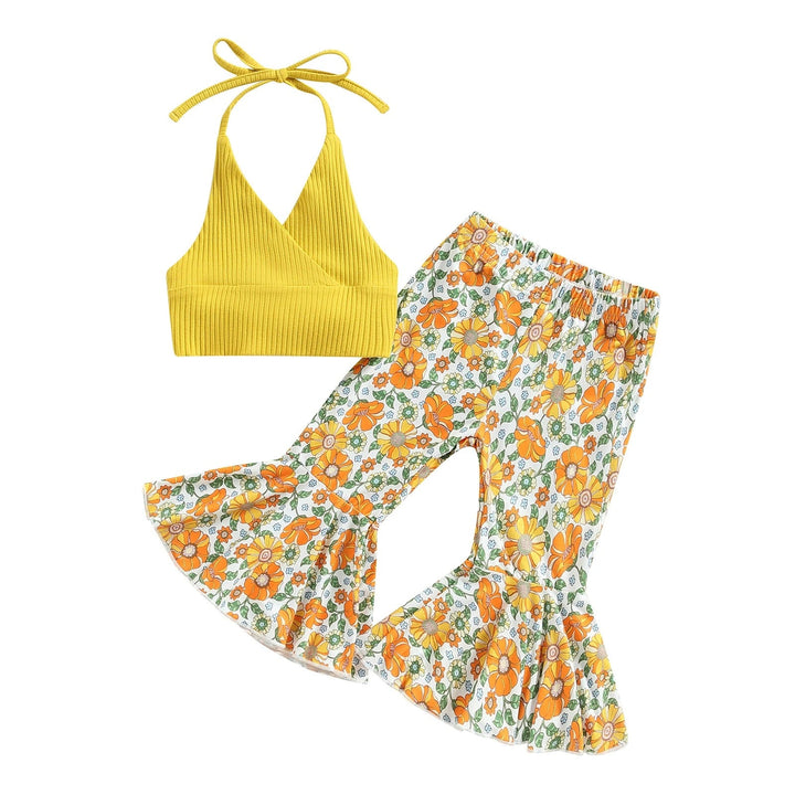 Yellow tie-neck halter top with green, orange and white floral flared pants.
