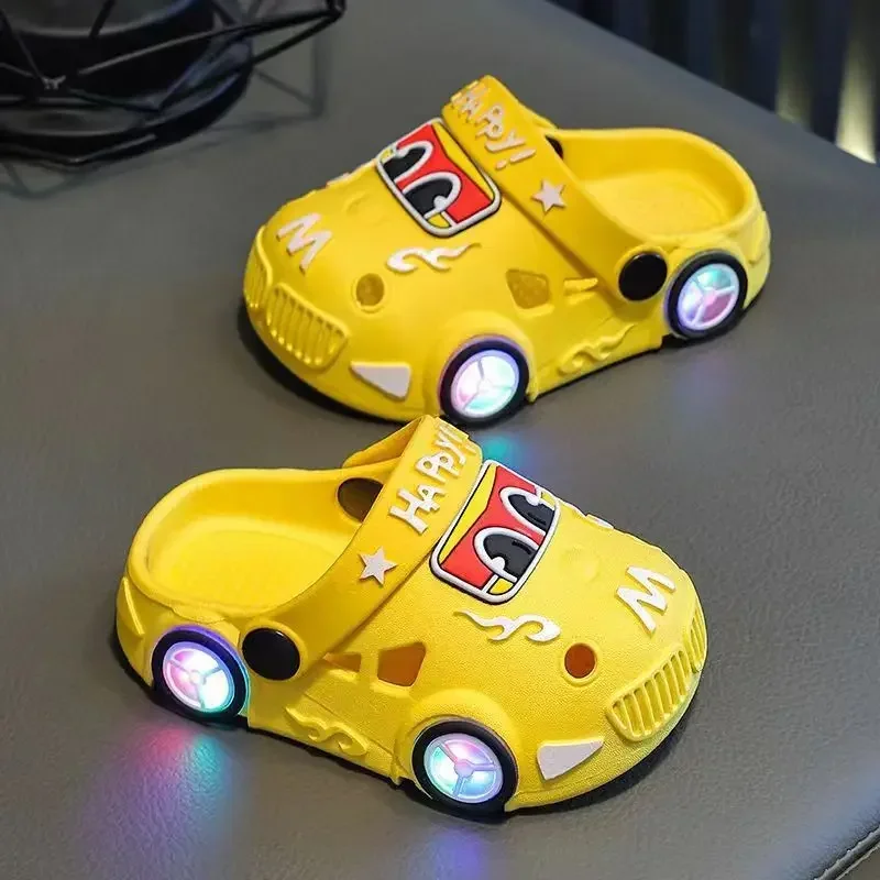 Yellow car slippers with glowing wheel-shaped lights and cartoon car faces.