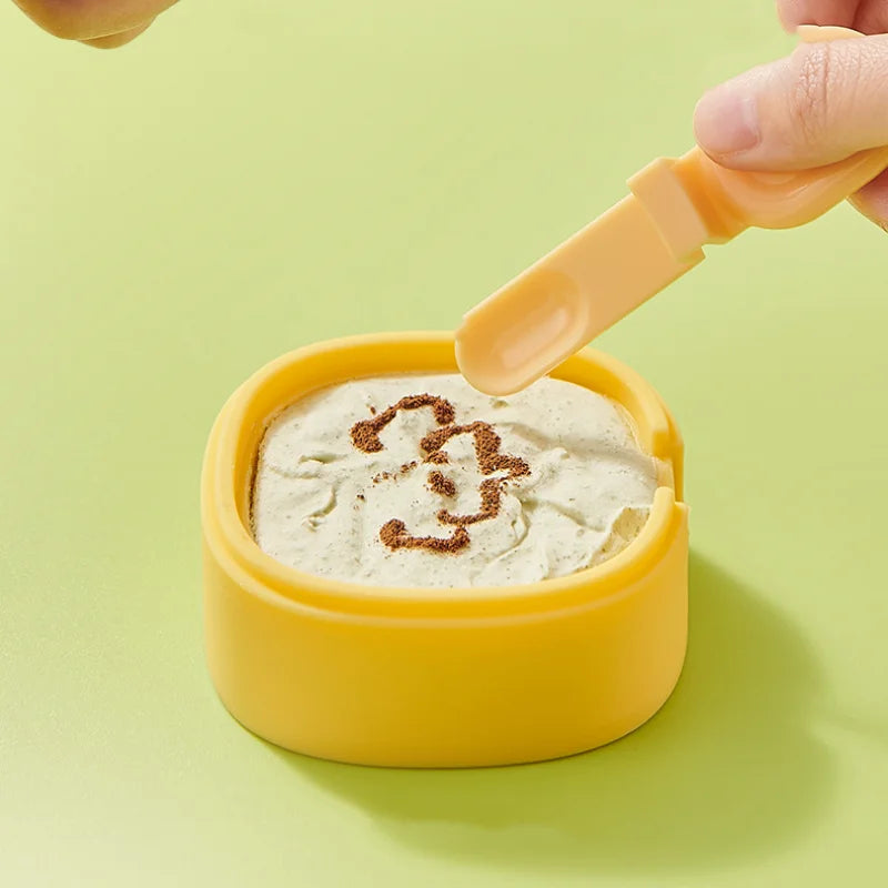 Spoon held above a creamy frozen dessert in a yellow ice cream mold.