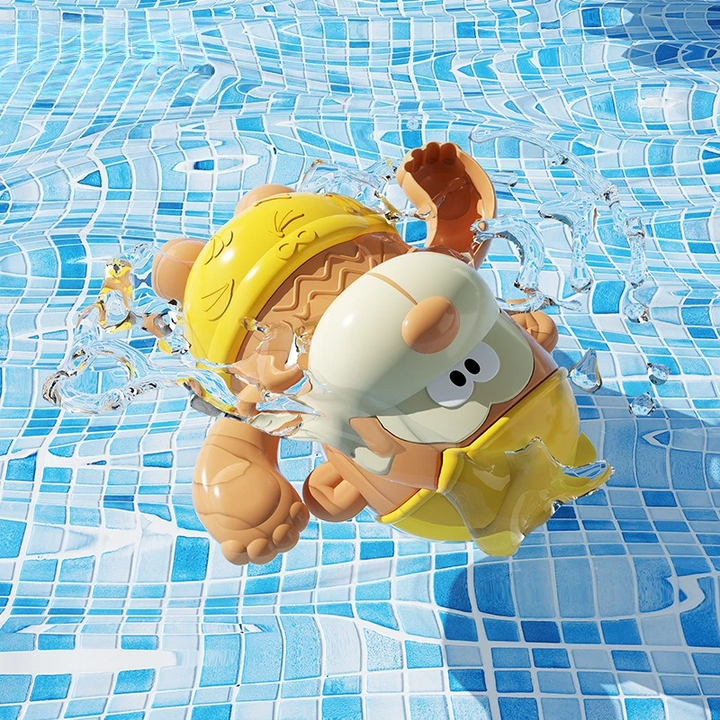 Yellow wind-up monkey bath toy tilted in blue-tiled pool water