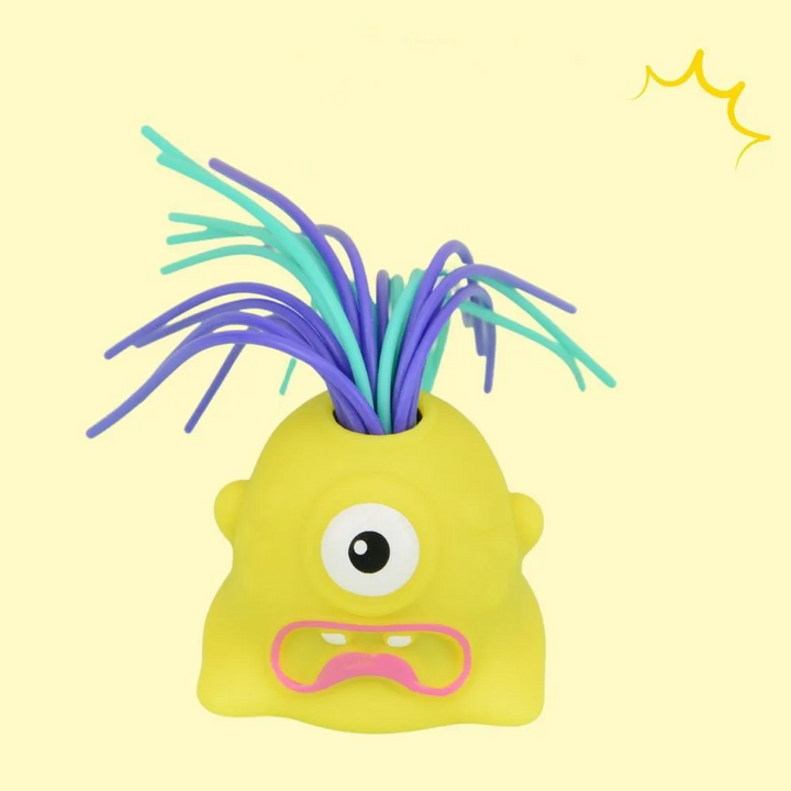 Yellow one-eyed monster stress toy with purple and mint-colored hair