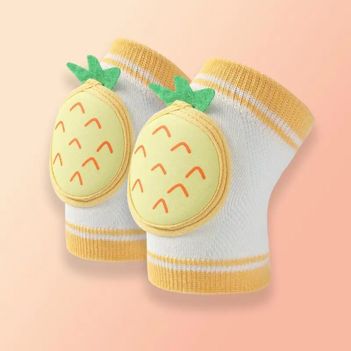 Pair of white knit knee pads with yellow pineapple fronts and yellow ribbed edges.