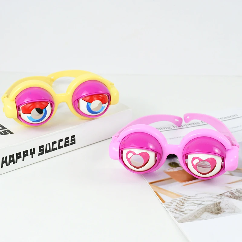 Yellow and pink blinking toy glasses displayed on a white tabletop