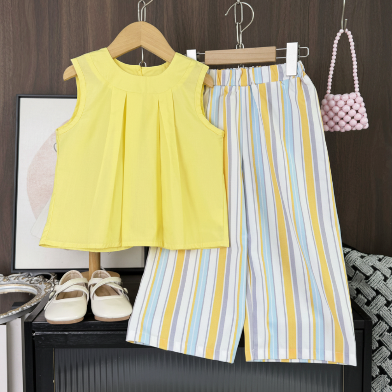 Yellow pleated sleeveless top paired with wide-leg pastel striped pants