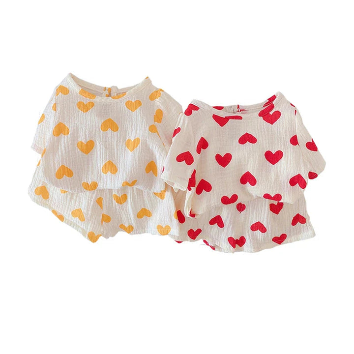 Matching cotton top and shorts sets with yellow or red hearts on a light background