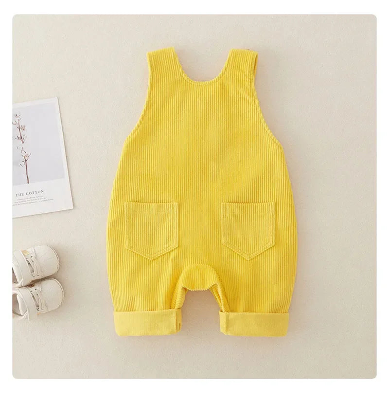Back of yellow ribbed baby overalls with two patch pockets and rolled cuffs
