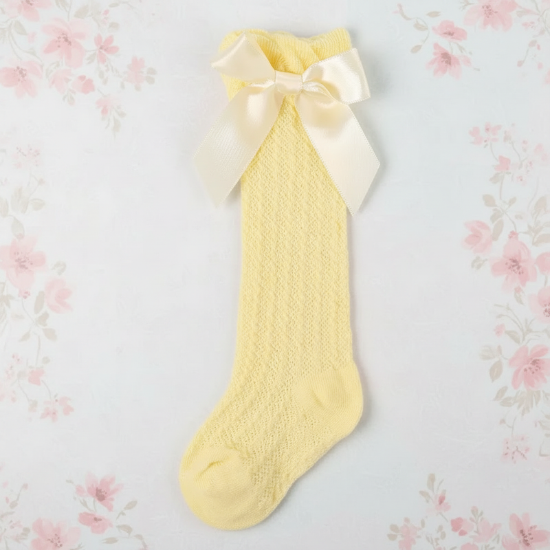 Yellow pointelle knee-high sock with a matching satin bow