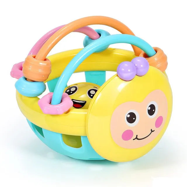 Yellow sensory chew toy with a smiling face and pink, orange, and turquoise arches