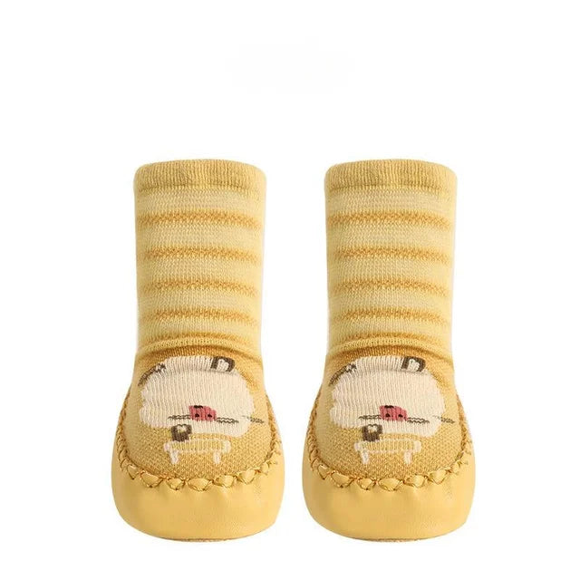 Yellow striped sock shoes with sheep faces, shown as a pair