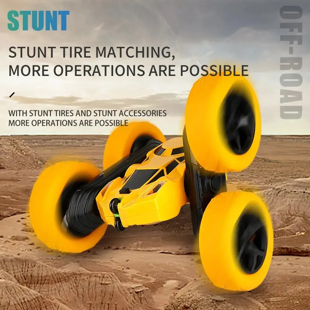 Yellow RC stunt car tilted on rough ground, showing its large textured tires