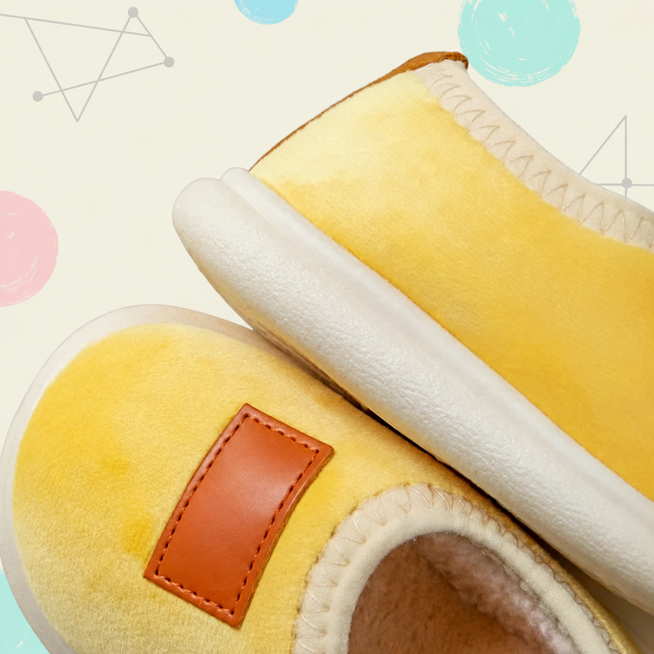 Yellow suede slippers showing cream-colored lining, stitched openings, and white soles