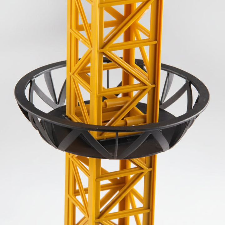 Black circular support brace around the yellow lattice tower.