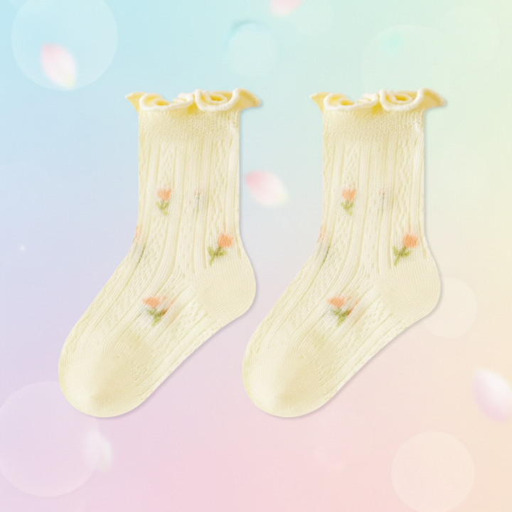 Pair of yellow baby socks with small floral accents and ruffled cuffs.