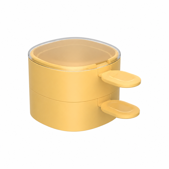 Two yellow ice cream molds stacked with matching spoons and a clear lid on top.