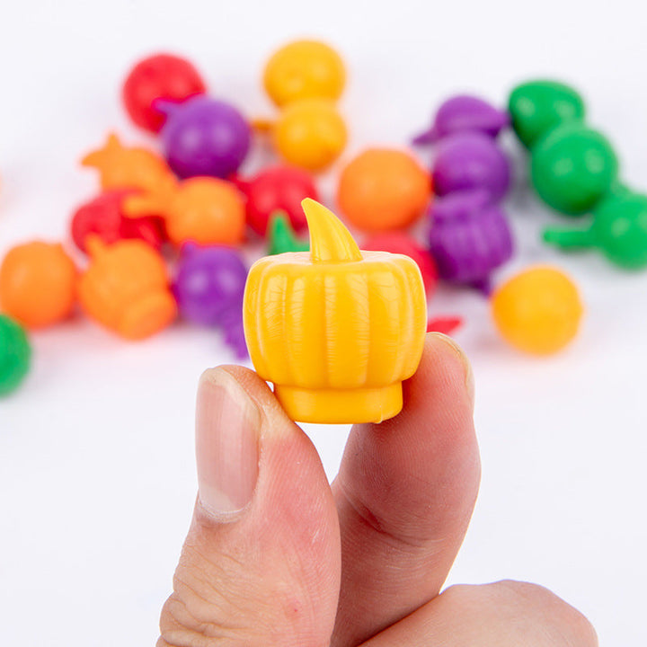 Close-up of a yellow vegetable play piece held between fingers, with more colorful pieces behind it