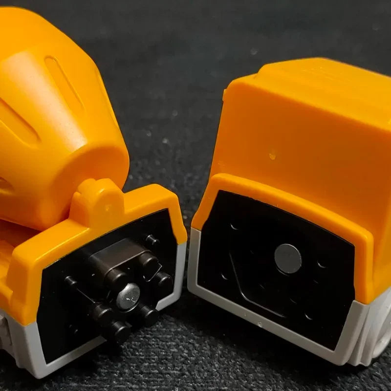 Close-up of magnetic connectors inside two yellow construction-vehicle sections.