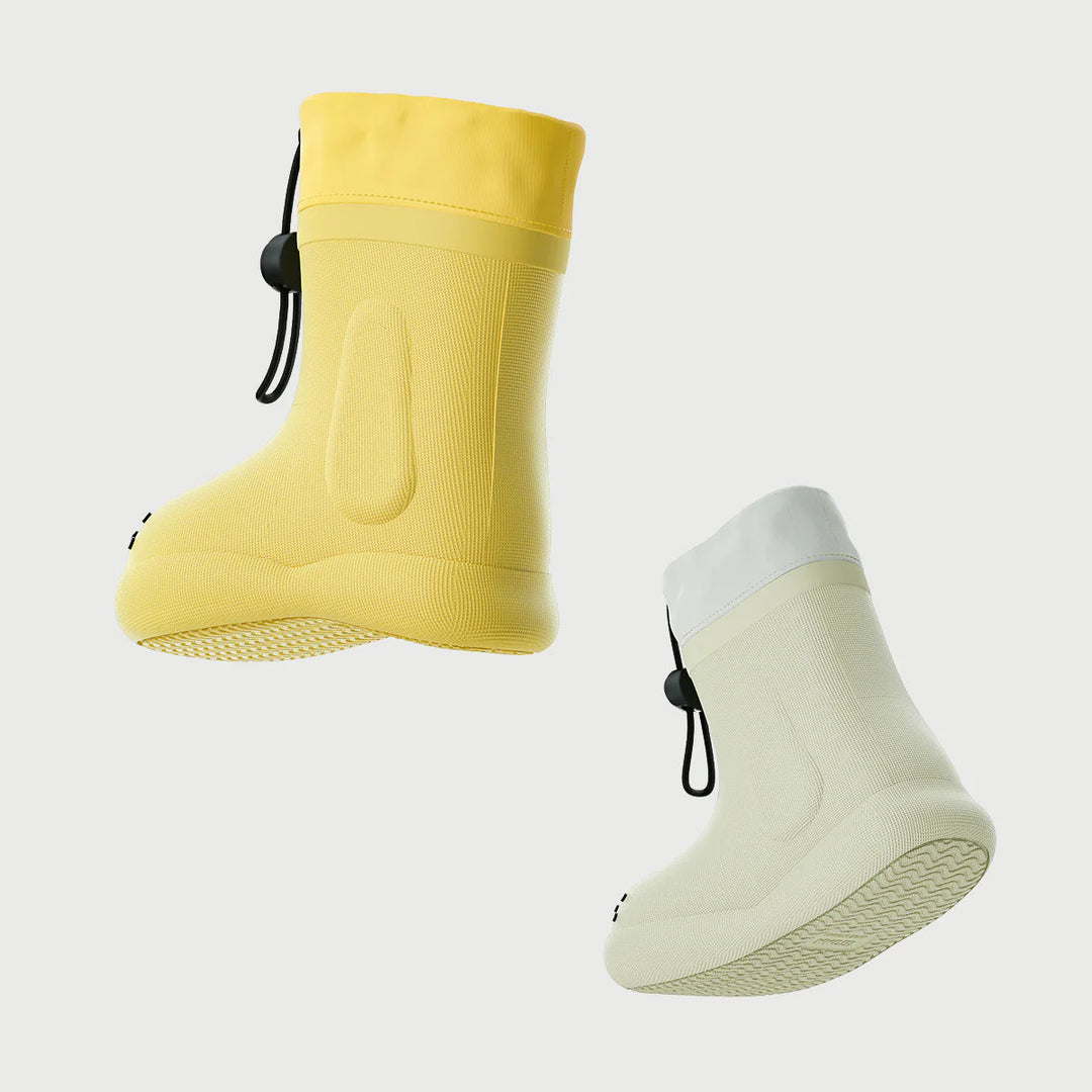 Yellow and white dog-face rain boots shown from the side with textured soles and drawcord cuffs