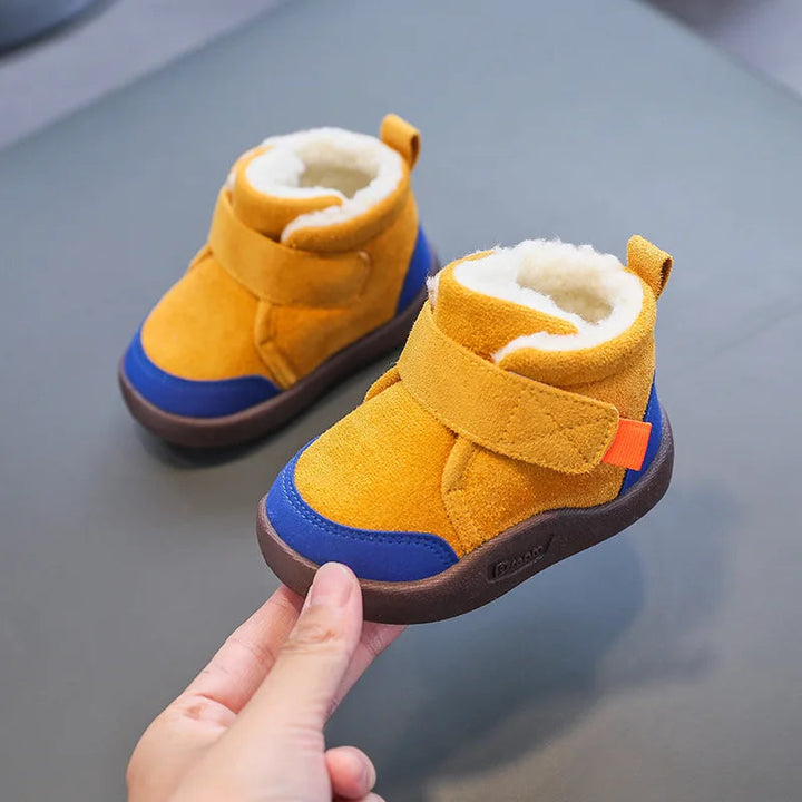 Yellow winter boots with blue toe panels, cream plush lining, and hook-and-loop straps