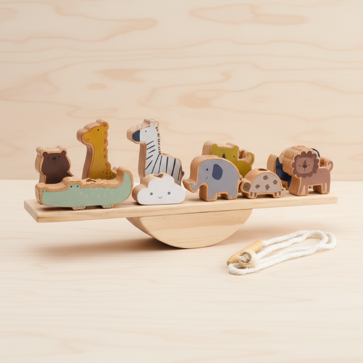 Animal-shaped wooden blocks on a balance board with a cord beside it